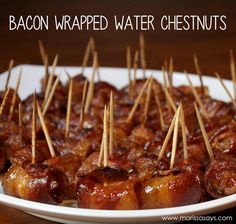 bacon wrapped water chestnuts on a plate with toothpicks in the foreground