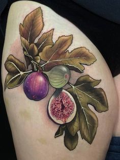 a woman's thigh with figs and leaves on it