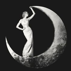 a woman in white dress standing on the moon