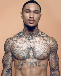 a shirtless man with tattoos on his chest and arms is looking at the camera