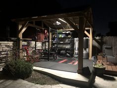 an outdoor gym is lit up at night with lights on and flowers in the foreground