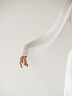 a woman's arm is wrapped in white fabric