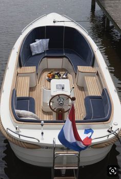 a small boat with a flag on the front