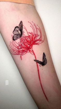 a woman's arm with two butterflies on it and a flower in the middle