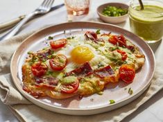 an egg and tomato pizza on a plate