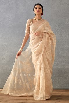 Beige hand block print saree with botanical dori embroidery and scallop border. Paired with padded and tassel detailed blouse.
Components: 2
Pattern: Embroidered, Printed
Type Of Work: Dori, Hand Block
Neckline: Leaf
Sleeve Type: Tassel
Fabric: Handwoven Chanderi, Cotton Silk, Silk Organza
Color: Beige
Other Details: 
Sheer back
Dori work
Occasion: Wedding,Bride - Aza Fashions Dori Embroidery, Dori Work, Scallop Border, Block Print Saree, Padded Blouse, Border Saree, Embroidery Hand, Blouse For Women, Hand Block Print