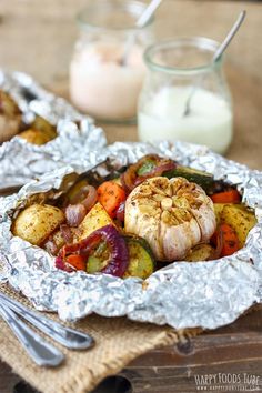 some food is sitting in tin foil on a table