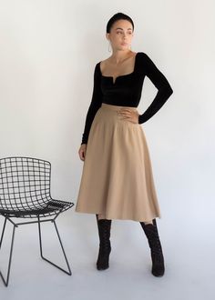 "Vintage 50s full wool skirt. This skirt is what vintage is about with its quality fabric and sweet details. High-waisted fit. Decorative dart waist. Below knee length. Voluminous full silhouette. Cut from a khaki quality wool fabric. Back hook and eye and zipper fastening. Fully lined. We kindly ask that you please view all measurements for comparison so you can get your desired fit. * Brand: n/a * Decade: 1950s * Fabric: Wool * Lining: Silk Crepe * Color: Kahki / Beige C O N D I T I O N Excell Chic Wool Midi Skirt, High Waist Retro Winter Skirt, High Waist Gathered Skirt For Fall, Chic Wool Flared Skirt, Retro High Waist Winter Skirt, Retro High-waist Winter Skirt, Chic Wool Flared Skirt Bottoms, Vintage Fitted Flared Skirt, Classic High Waist Skirt For Fall