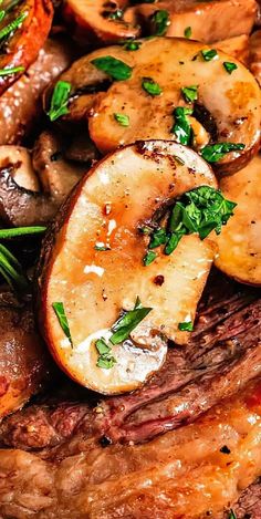 closeup of steak with mushrooms and parsley on top