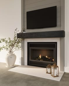 a living room with a fireplace and television mounted above the fire place in front of it