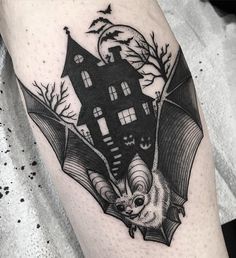 a black and white image of a bat with a house on it's back