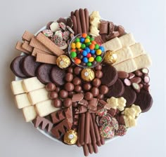 a platter filled with lots of different types of candy and candies on top of each other