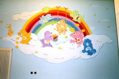 there are many teddy bears flying in the sky with a rainbow painted on the wall