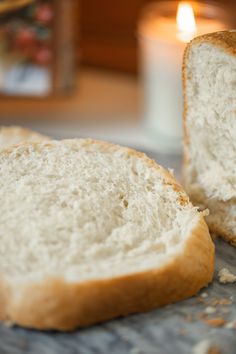 a loaf of bread sitting on top of a table next to a candle