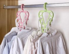 three clothes hangers are hanging on a rail