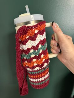 a woman is holding a coffee cup holder