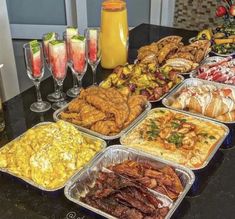 a table topped with trays of food and drinks