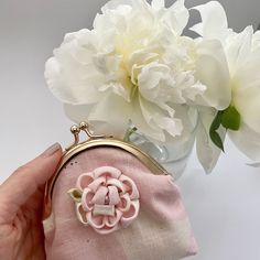 "Rose Gold Kisslock Coin Purse, also known as \"Gamaguchi\" in Japan.  Made with Pink/White \"Muddy Works\" pink light weight cotton canvas fabric and adorned with a Kanzashi peony flower, this compact purse is a stylish accessory. Its metal clasp closure provides easy access, while the beige/pink floral cotton lining adds a touch of elegance. Our Rose Gold Kisslock Coin Purse is a testament to impeccable craftsmanship and attention to detail. Its elegant design, combined with the traditional elements of Kanzashi, creates a unique and eye-catching piece.  It's perfect for your essentials. Elevate your style with this beautifully crafted coin purse. Finish size (approximate) 10cm (L) x 11cm (H) x 2cm (W)" Vintage Pink Wallets For Gifts, Pink Vintage Wallets For Gifts, Vintage Pink Coin Purse As Gift, Pink Vintage Style Coin Purse Gift, Handmade Pink Pouch Coin Purse, Pink Pouch Coin Purse Gift, Pink Pouch Coin Purse As Gift, Handmade Pink Coin Purse, Vintage Pink Wallet For Everyday