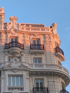 an ornate building with balconies on the top and balcony railings above it