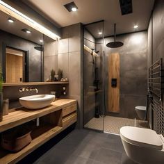 a bathroom with a sink, toilet and shower stall in the middle of the room