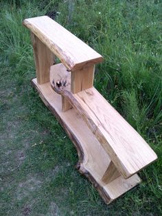 a wooden bench sitting on top of a lush green field