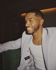 a man sitting in a chair smiling for the camera