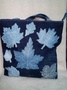 a denim bag with blue leaves on it