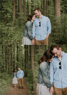 a man and woman standing in the woods with their arms around each other as they look at each other