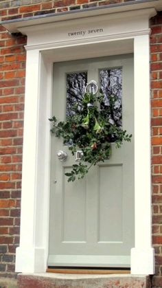 a green door with a wreath on it