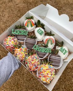 a box filled with chocolate covered strawberries on top of a brown carpeted floor