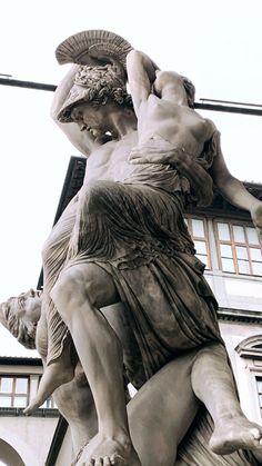 an image of a statue that is in front of a building