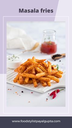 masala fries on a white plate with ketchup and mustard in the background