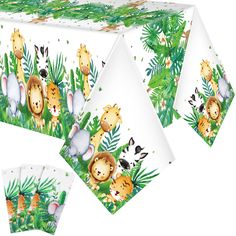 a table cloth with animals on it and jungle leaves in the background, including giraffes