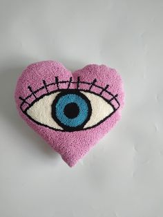 a pink heart with an eye patch on it