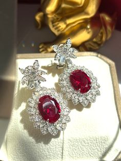 Luxury Ruby Jewelry With Rectangular Stone, Luxury Ruby Earrings For Parties, Luxury Adjustable Ruby Jewelry, Luxury Red Diamond Earrings With Gemstone, Luxury Classic Lab-created Ruby Jewelry, Luxury Ruby Gemstone Earrings, Luxury Oval Ruby Earrings, Exquisite Prong Set Drop Earrings, Luxury Hallmarked Ruby Earrings