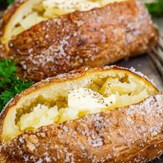 two loaves of bread sitting on top of a cooling rack with parmesan cheese