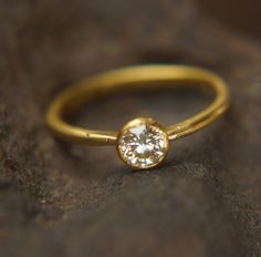 gold diamond ring//24k gold diamond ring//diamond engagement ring//24k gold engagement//artisan diamond ring//boho engagement ring the listing is for 24k gold ring with 0.5 ct diamond stone. Stones are white diamond 0.5 ct VS 5 mm diameter wire/ring shank 22k gold bezel diamond setting in 24k gold. In my years of experience i got the notion that many grooms bought the wrong design for their engagement ring. its true in my point of view. so I choose to pickup the glove on this and make my own col Artisan Diamond Rings, Boho Engagement Ring, Boho Engagement, Rough Diamond Ring, Emerald Ring Gold, Titanium Wedding Rings, Titanium Wedding Band, Etsy Wedding Rings, Gold Diamond Ring