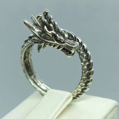 The Adjustable Dragon Ring is a piece of jewelry featuring a dragon design. It is typically made of metal, such as silver or gold, and may be adorned with details such as gemstones or enamel. The ring is designed to be adjustable, allowing it to be worn on any finger regardless of size. The dragon design on the ring may be stylized and decorative, or it may be more realistic and detailed. The Adjustable Dragon Ring is a popular choice for those who are fans of fantasy and mythical creatures, and Sugar Skull Ring, Hug Ring, Horn Ring, Gothic Elegance, Gothic Ring, Dragons Gift, Dragon Ring, Head Ring, Dragon Lover