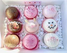 a box filled with different types of cupcakes