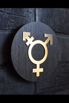 a wooden sign with an image of a male and female symbol on it's side