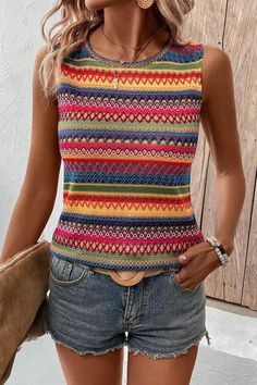 Embrace sunny days in this top, exuding bohemian charm with its vibrant hue and intricate design.The sleeveless style offers freedom of movement, perfect for casual outings or layering under a jacket for a versatile look.Featuring a round neck, this top provides a classic silhouette that is easy to style up or down for various occasions.The ethnic wavy pattern adds a unique touch, making this top a standout piece in any wardrobe.Designed for comfort and style, this tank top is a must-have for th Multicolor Hippie Tank Top For Beach, Hippie Multicolor Tank Top For Beach, Hippie Multicolor Tank Top For Festival, Multicolor Sleeveless Top For Spring, Fitted Multicolor Beach Vest, Spring Multicolor Stretch Vest, Casual Festival Tops With Colorful Pattern, Multicolor Vest Tank Top For Festival, Bohemian Multicolor Print Tops For The Beach