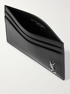 SAINT LAURENT's accessories are so classic and timeless. This cardholder is made from smooth leather and detailed simply with the house's storied monogram plaque and four slots. The streamlined shape will be barely noticeable when it's in your pocket. Saint Laurent Card Holder, Saint Laurent Collection, Leather Cardholder, Black Wallet, Latest Sneakers, Card Holder Wallet, Leather Silver, Card Holder Leather, Black Logo