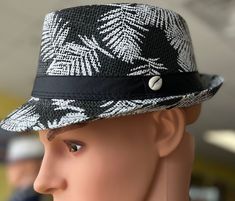 This hat for the person with unique style of fashion.Black and white Fedora with a cowrie shell and black band design around crown .This Fedora is beautiful and unisex. The fedora looks great for the summer. Comfortable fits small to med size heads.Don't delay order yours today. White Casual Fedora For Outdoor, Casual White Fedora For Outdoor, White Adjustable Panama Hat Casual Style, Casual White Hat Band For The Beach, Casual White Hat Band For Beach, White Casual Panama Hat For Outdoor, Casual White Panama Hat For Outdoor, Casual Adjustable White Panama Hat, Casual White Adjustable Panama Hat