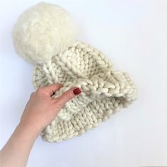 This is our BESTSELLER chunky knit hat! This super warm winter wool hat is made of luxurious merino yarn of our own production. It is rather thick, warm, soft, cuddly and silky to the touch. Looks super chunky with a large detachable pom-pom. So you can wear it with or without pom-pom. COLOR - choose from more than 60 rich colors. FIBER - lightly felted hand-spun yarn. Depending on a color the yarn can be made of 100 % extra fine merino wool 18,5 mc or 70% extra fine merino wool 18,5 mc and 30% Cozy Chunky Knit Hat, Cozy Chunky Knit Beanie, Cozy Merino Wool Beanie With Soft Knit, Cozy Knitted Merino Wool Beanie, White Cozy Chunky Knit Hat, Giant Pom Pom, Beanie With Pom Pom, Chunky Knit Beanie, Hat With Pom Pom