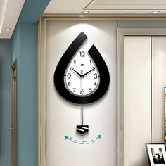 a clock that is on the side of a wall next to a painting and pictures