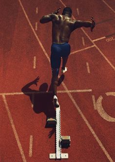 a man is running on a red track