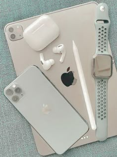 an apple watch, headphones, and other electronics on a table