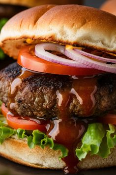 Close-up of a juicy hamburger with lettuce, tomato, red onion, and barbecue sauce. Yogurt Sauces, Ultimate Burger, Tangy Bbq Sauce