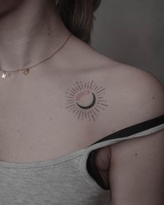 a woman with a sun and moon tattoo on her chest