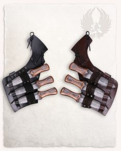 four pairs of leather gloves with metal handles and straps on white background, top view